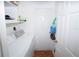 Functional laundry room featuring a washer, dryer, and storage shelving at 2773 Woodstream Cir, Kissimmee, FL 34743