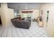 Bright living room featuring tile flooring, a sectional sofa, and access to the backyard at 2773 Woodstream Cir, Kissimmee, FL 34743