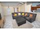 Inviting living room with tile flooring, a comfortable sectional sofa, and ample natural light at 2773 Woodstream Cir, Kissimmee, FL 34743