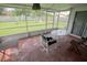 Enclosed patio with playful chalk drawings and view of the backyard, including a swing set and slide at 2773 Woodstream Cir, Kissimmee, FL 34743