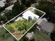 Expansive property featuring lush greenery, a modern home with a white roof, and mature trees at 2900 Wessex St, Orlando, FL 32803