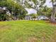 Large backyard featuring an open lawn, mature shade trees, and an outdoor seating area at 2900 Wessex St, Orlando, FL 32803