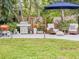 Backyard patio featuring a grill, lawn and comfortable lounge seating, perfect for outdoor gatherings at 2900 Wessex St, Orlando, FL 32803