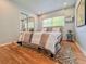 Cozy bedroom with wood floors, striped bedding, closet with mirrored doors and ample natural light at 2900 Wessex St, Orlando, FL 32803
