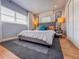 Cozy bedroom with a tufted headboard, soft lighting and large window, creating a relaxing ambiance at 2900 Wessex St, Orlando, FL 32803