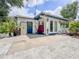 Exterior showcasing the back of the house, with a blue door, patio and a spacious driveway at 2900 Wessex St, Orlando, FL 32803