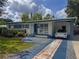 Inviting home featuring a colorful walkway, landscaping, and covered carport with parking at 2900 Wessex St, Orlando, FL 32803