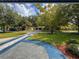 Lush front yard view features mature trees and an extended driveway, enhancing the home's curb appeal at 2900 Wessex St, Orlando, FL 32803