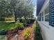 Beautiful landscaping featuring a mix of plants, trees, and mulch surrounding the home's exterior at 2900 Wessex St, Orlando, FL 32803