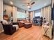 Inviting living room with hardwood floors, ceiling fan, leather seating and desk workstation at 2900 Wessex St, Orlando, FL 32803
