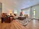Cozy living room featuring hardwood floors, a neutral sofa, and ample natural light at 2900 Wessex St, Orlando, FL 32803