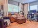 Inviting living room with hardwood floors, leather seating, natural light and a blue guitar hanging on the wall at 2900 Wessex St, Orlando, FL 32803