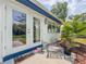 Inviting patio area with French doors, a small table, a chair and a 'Nice Home Paws' welcome mat at 2900 Wessex St, Orlando, FL 32803