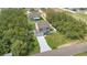 An aerial view of a home surrounded by green trees in a quiet residential neighborhood at 303 Anchovie Ct, Poinciana, FL 34759