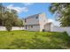 View of a home's backyard featuring a fenced yard with green grass and an air conditioner unit at 303 Anchovie Ct, Poinciana, FL 34759