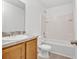 Bathroom features a vanity sink and tub with shower at 303 Anchovie Ct, Poinciana, FL 34759