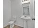 Bathroom features a pedestal sink and standard toilet at 303 Anchovie Ct, Poinciana, FL 34759