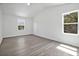 Sunlit bedroom features two windows and light wood-look flooring at 303 Anchovie Ct, Poinciana, FL 34759