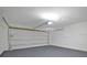 Garage with white door and opener at 303 Anchovie Ct, Poinciana, FL 34759