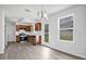 Well-lit kitchen with stainless steel appliances, wood cabinets, vinyl floors, and a view to the backyard at 303 Anchovie Ct, Poinciana, FL 34759