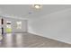 Bright living room showcasing wood-look flooring, and an open view to the kitchen and backyard at 303 Anchovie Ct, Poinciana, FL 34759