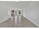 Bright living room showcasing wood-look flooring, and an open view to the kitchen at 303 Anchovie Ct, Poinciana, FL 34759