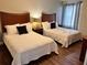 Inviting bedroom featuring two beds, soft lighting, and charming decor at 3100 Parkway Blvd # 417, Kissimmee, FL 34747