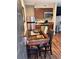 Cozy kitchenette featuring modern appliances, granite counters, and a dining table at 3100 Parkway Blvd # 417, Kissimmee, FL 34747