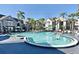 Large community pool featuring ample space and hot tub surrounded by well-maintained landscaping at 3100 Parkway Blvd # 417, Kissimmee, FL 34747