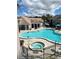 Inviting pool and spa area with poolside seating and well-maintained landscaping at 3100 Parkway Blvd # 417, Kissimmee, FL 34747