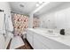 Bright bathroom featuring a double sink vanity, floral shower curtain and modern fixtures at 3144 Dark Sky Dr, Harmony, FL 34773