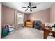 Bedroom featuring a crib, rocking chair, and neutral color palette at 3144 Dark Sky Dr, Harmony, FL 34773