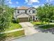 Charming two-story home featuring a well-manicured lawn and a welcoming front porch with columns and a two car garage at 3144 Dark Sky Dr, Harmony, FL 34773
