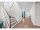 Grand foyer with wood-look flooring, a staircase with decorative banisters, and an abundance of natural light at 3144 Dark Sky Dr, Harmony, FL 34773