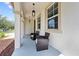 Inviting front porch with comfortable seating area and stylish lighting, perfect for enjoying outdoor relaxation at 3144 Dark Sky Dr, Harmony, FL 34773