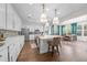 Spacious kitchen with white cabinets, quartz countertops, stainless appliances, large island and adjacent dining area at 3144 Dark Sky Dr, Harmony, FL 34773