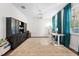 Bright home office featuring large window, modern desk, and stylish furniture for a productive workspace at 3144 Dark Sky Dr, Harmony, FL 34773