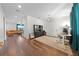 Home office with dark hardwood floors, built-in shelving and cabinets, and an elegant overhead light fixture at 3144 Dark Sky Dr, Harmony, FL 34773