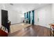 Home office featuring dark hardwood floors, bright natural light, and calming blue curtains at 3144 Dark Sky Dr, Harmony, FL 34773