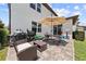 Outdoor patio with BBQ grill, patio seating, umbrella and pavers at 3144 Dark Sky Dr, Harmony, FL 34773