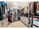 Organized walk-in closet with custom shelving, drawers, and ample hanging space for clothes and shoes at 3144 Dark Sky Dr, Harmony, FL 34773