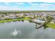 Aerial view showcasing the community pool and dock on the serene lake at 3212 Preserve Dr, Orlando, FL 32824
