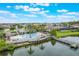 Breathtaking view of lakeside neighborhood pool, dock, and lush tropical landscaping at 3212 Preserve Dr, Orlando, FL 32824