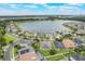 Beautiful lakeside homes featuring manicured lawns, mature trees, and a serene water view at 3212 Preserve Dr, Orlando, FL 32824