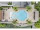 Overhead shot of community pool area with splash pad, surrounded by palm trees at 3212 Preserve Dr, Orlando, FL 32824