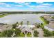 Aerial showcasing a lakefront community center, pool, and a scenic lake at 3212 Preserve Dr, Orlando, FL 32824