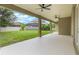 Covered back porch offers views of the fenced-in yard, landscaping, and nearby homes at 3212 Preserve Dr, Orlando, FL 32824