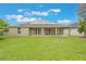 Large backyard featuring green grass, lush landscaping, solar panels and a fire pit at 3212 Preserve Dr, Orlando, FL 32824