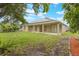 Expansive backyard includes a covered patio, green lawn, and beautiful lush landscaping at 3212 Preserve Dr, Orlando, FL 32824