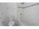 Bright bathroom with white tiled walls, mosaic tile accent, and a bathtub with shower at 3212 Preserve Dr, Orlando, FL 32824